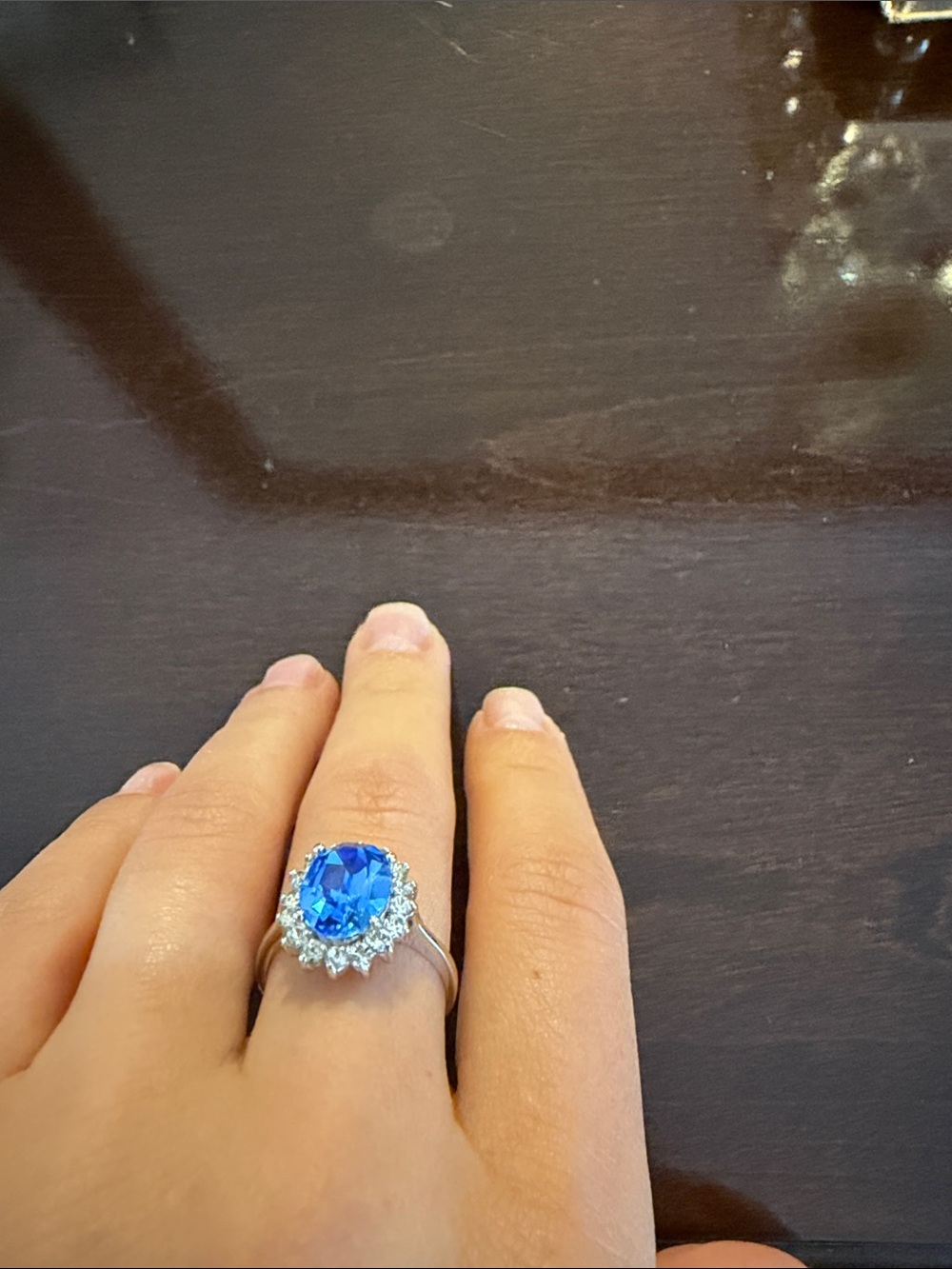 Silver Ring with Bright Blue Center Stone and Halo